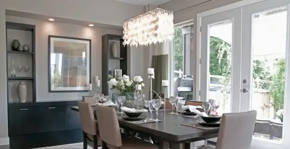 Elegant dining room chandelier installation above table in Wilmington, NC
