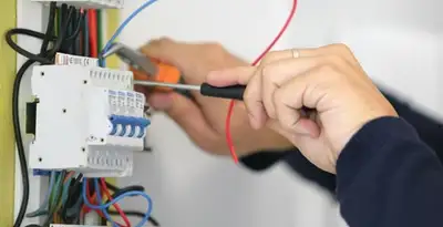 Electrician installing and adjusting circuit breakers in an electrical panel in Wilmington, NC