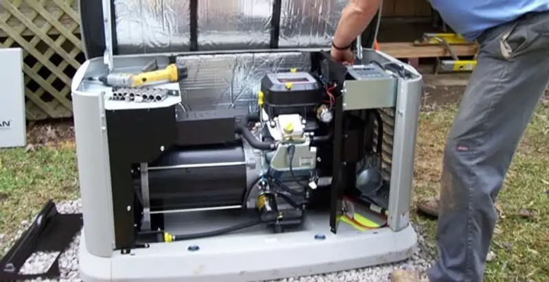 generator installation service showing technician connecting and configuring generator components in Wilmington, NC