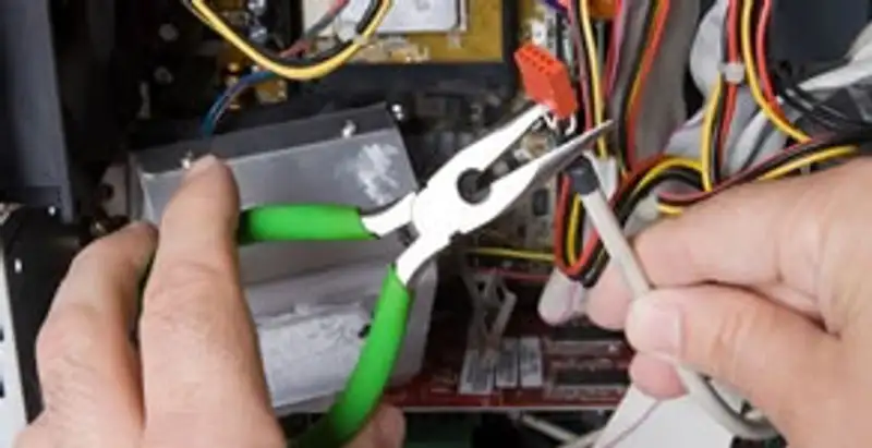 Licensed electrical contractor performing electrical repair with tools in Castle Hayne, NC