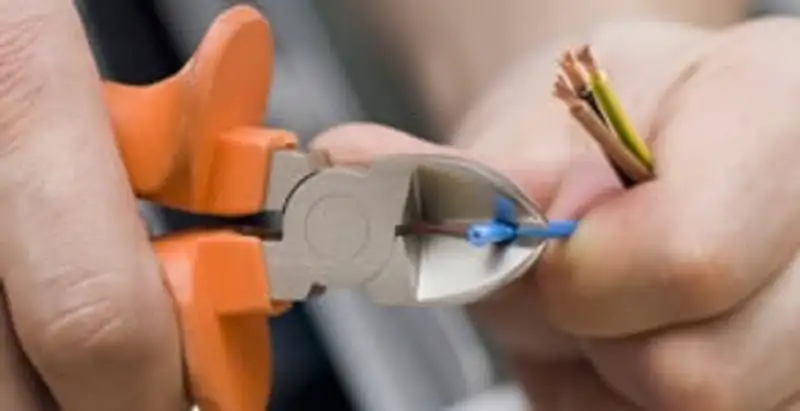 professional electrical services showing precise wire cutting by licensed electricians in Wilmington, NC