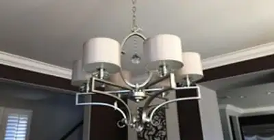 Modern chandelier installation with multiple light fixtures in Wilmington, NC