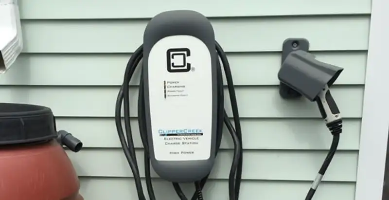 Outdoor electric vehicle charger installation on residential wall in Wilmington, NC
