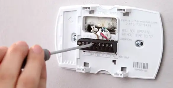 Thermostat installation service with proper wiring and secure wall mounting in Wilmington, NC